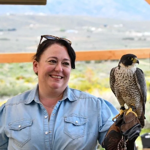 Christine Zack with a falcon during an outdoor learning visit.