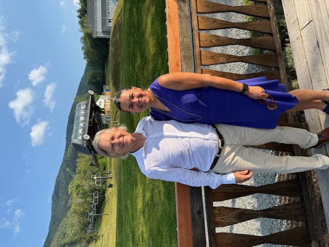 Jim Harleen and Stephanie DiMarco standing together at a mountain resort.